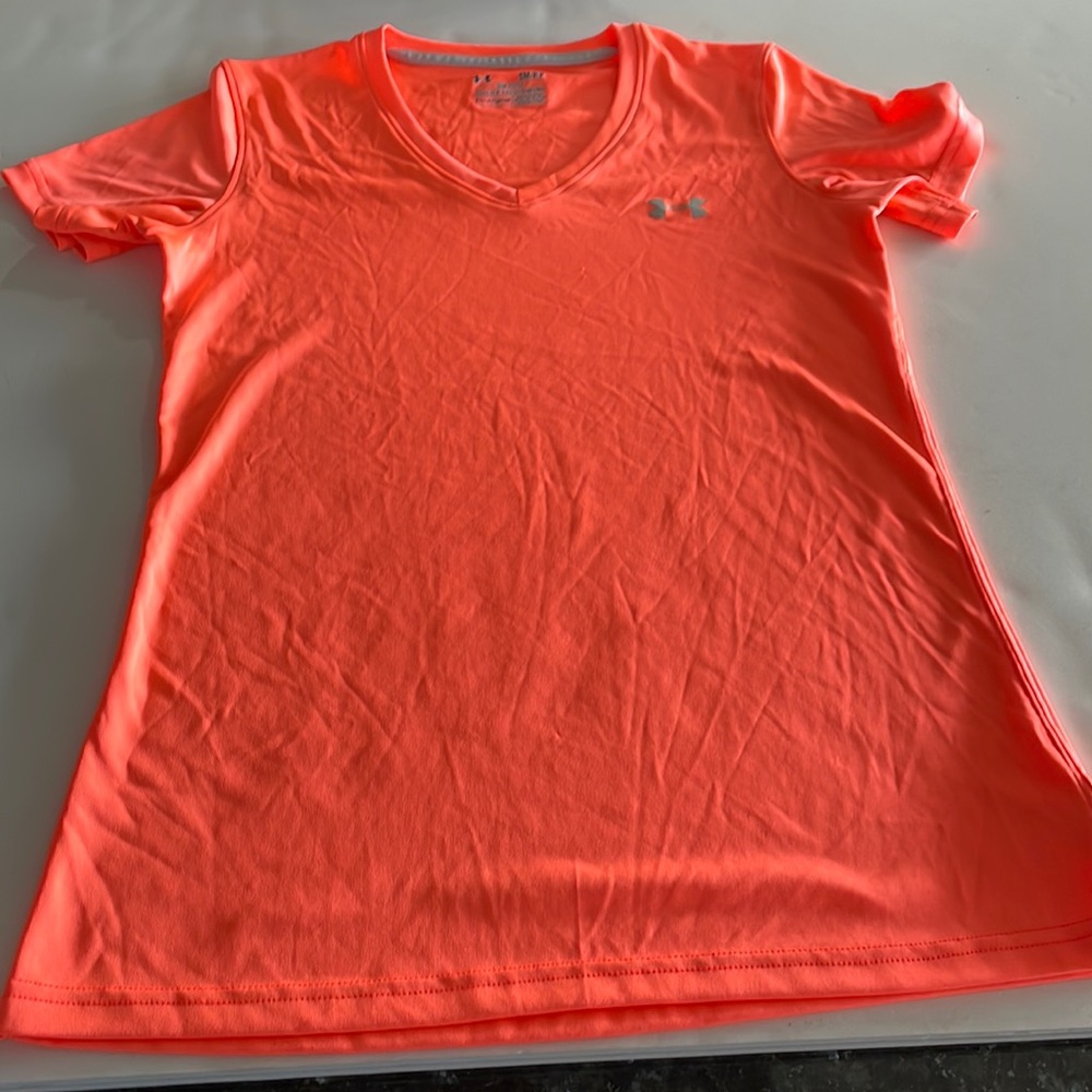 Under Armour heat gear top size SM/P/P. I’m a peachy orange color.